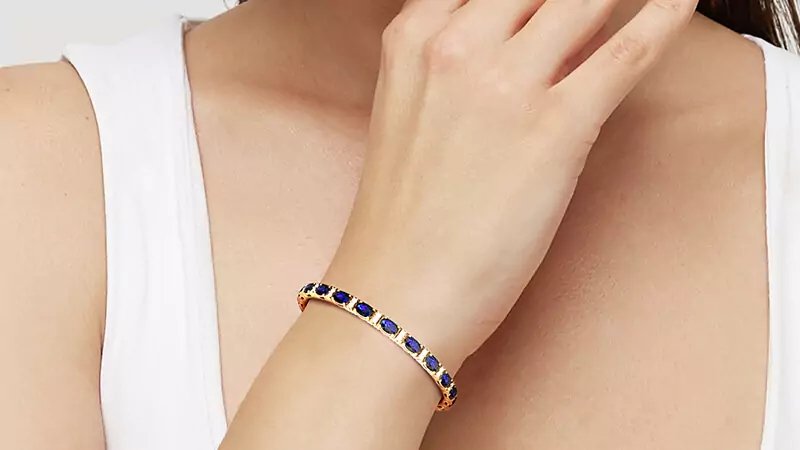 A girl wearing a sapphire tennis bracelet